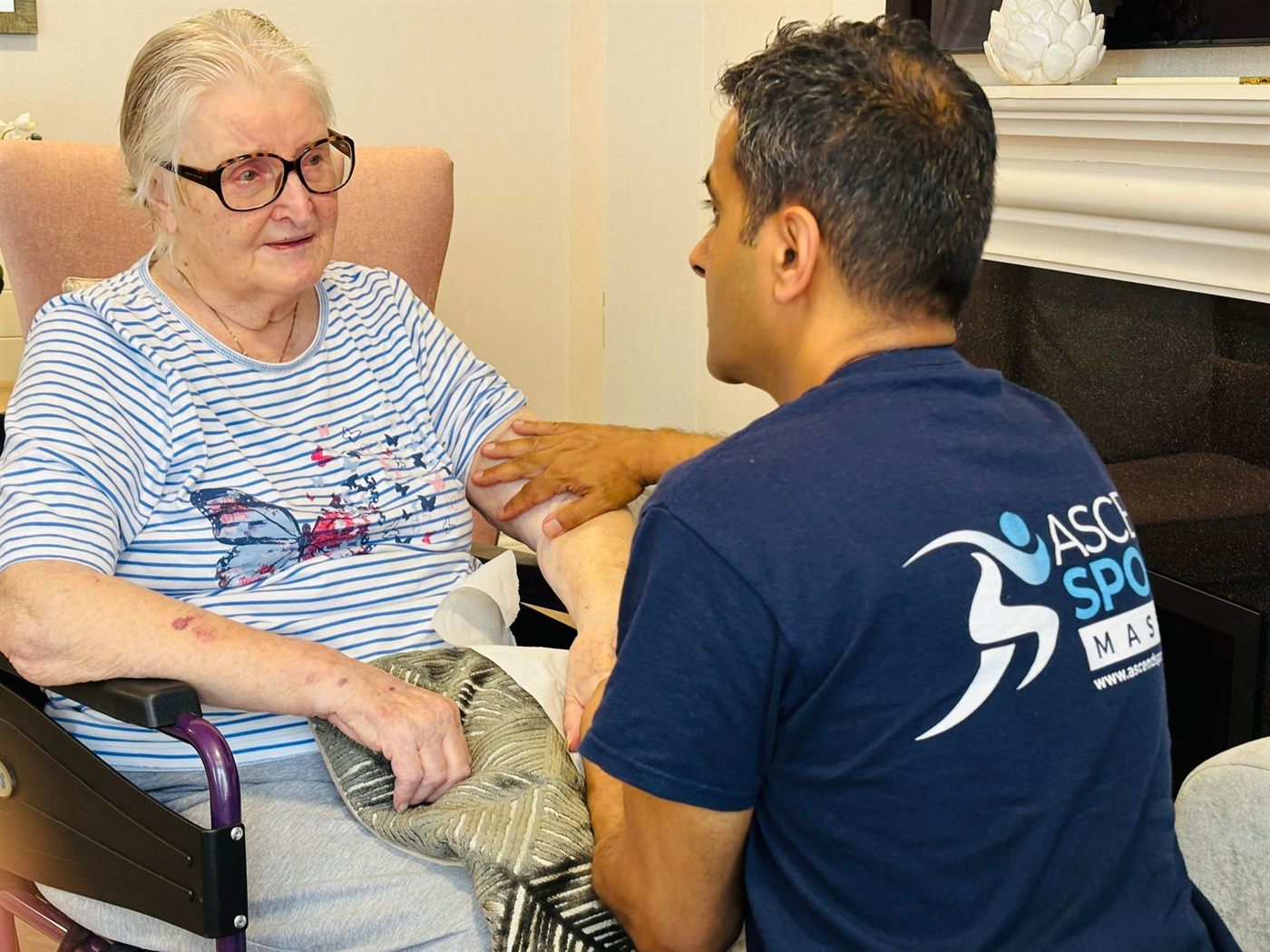 Pramod chatting warmly with a care-home resident during a relaxing visit