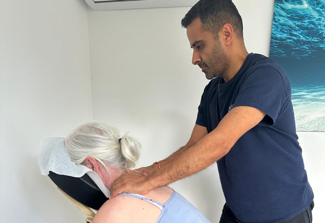 Colleague enjoying a short seated chair massage