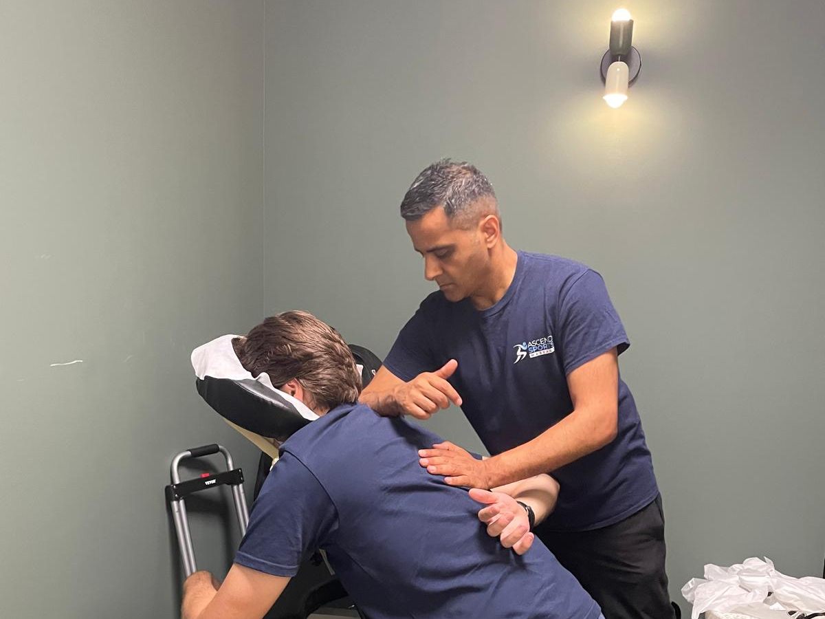Pramod giving an on-site seated chair massage to a client in the portable massage chair